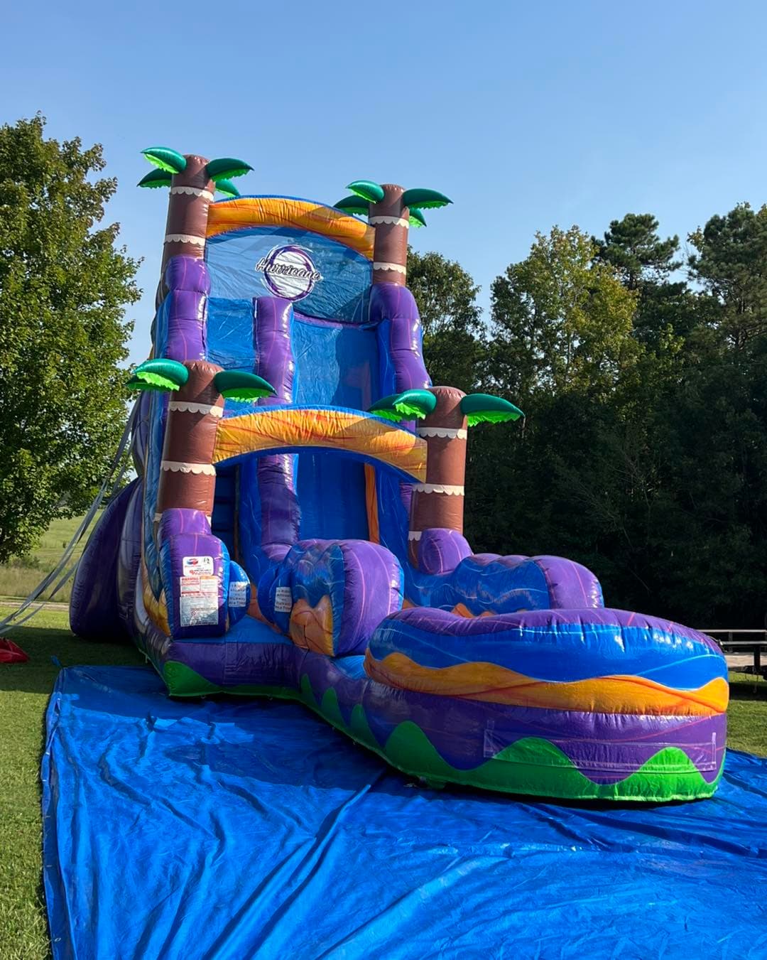 A large Jumping Jax tropical waterslide set up outdoors