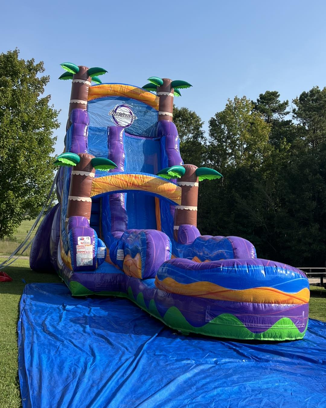 A large Jumping Jax tropical waterslide set up outdoors